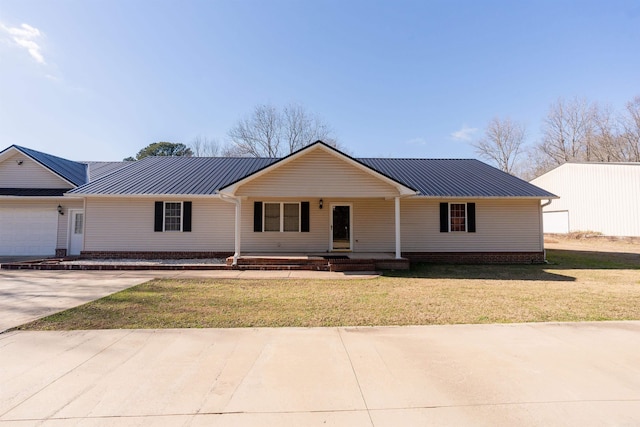 single story home featuring covered porch, a garage, and a front lawn