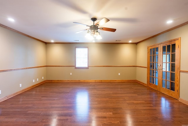 empty room featuring dark hardwood / wood-style flooring, ceiling fan, french doors, and ornamental molding