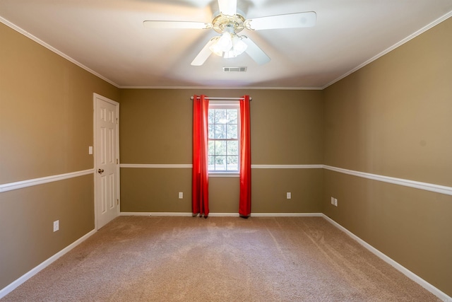 carpeted empty room featuring ceiling fan and crown molding