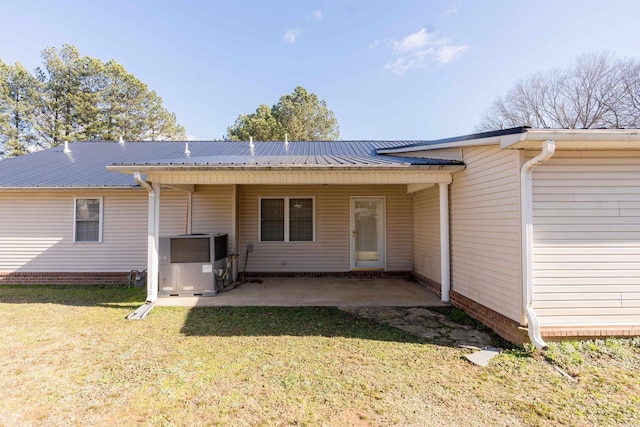 rear view of property featuring a patio area and a yard