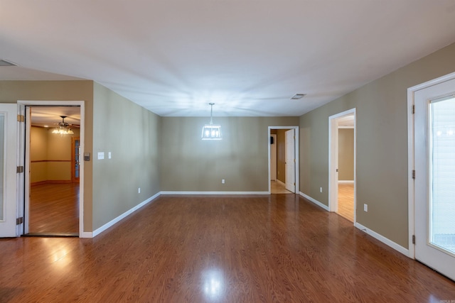 spare room featuring dark hardwood / wood-style floors and a healthy amount of sunlight