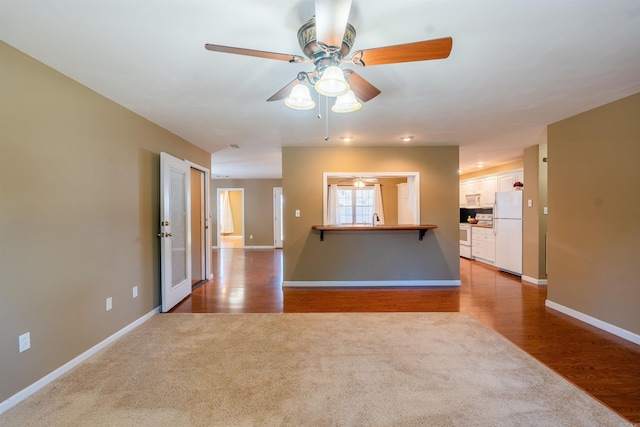 spare room featuring ceiling fan, sink, and light hardwood / wood-style floors