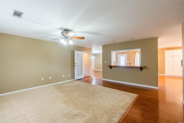 unfurnished room featuring ceiling fan and dark wood-type flooring