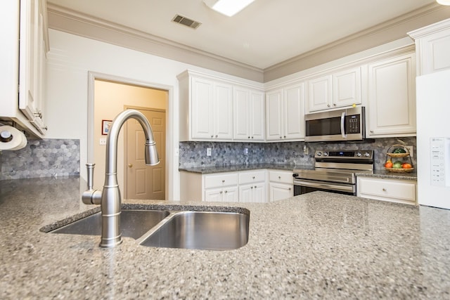 kitchen with sink, stainless steel appliances, decorative backsplash, white cabinets, and ornamental molding