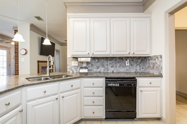 kitchen with stone countertops, sink, black dishwasher, decorative light fixtures, and white cabinetry