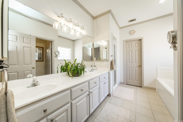 bathroom featuring tile patterned floors, a bathing tub, vanity, and ornamental molding