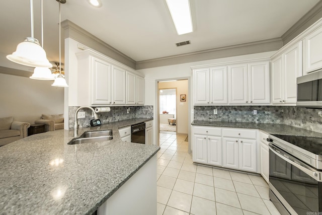 kitchen featuring sink, hanging light fixtures, dark stone countertops, appliances with stainless steel finishes, and white cabinetry