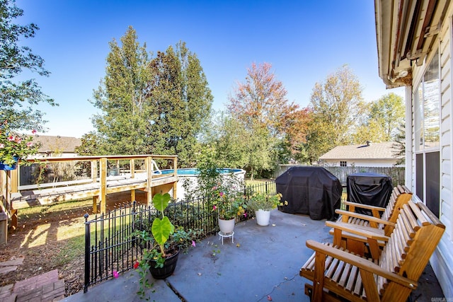 view of patio / terrace featuring a grill and a fenced in pool