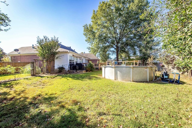 view of yard with a fenced in pool