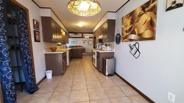 kitchen featuring white range with electric cooktop, dark brown cabinetry, and light tile patterned flooring