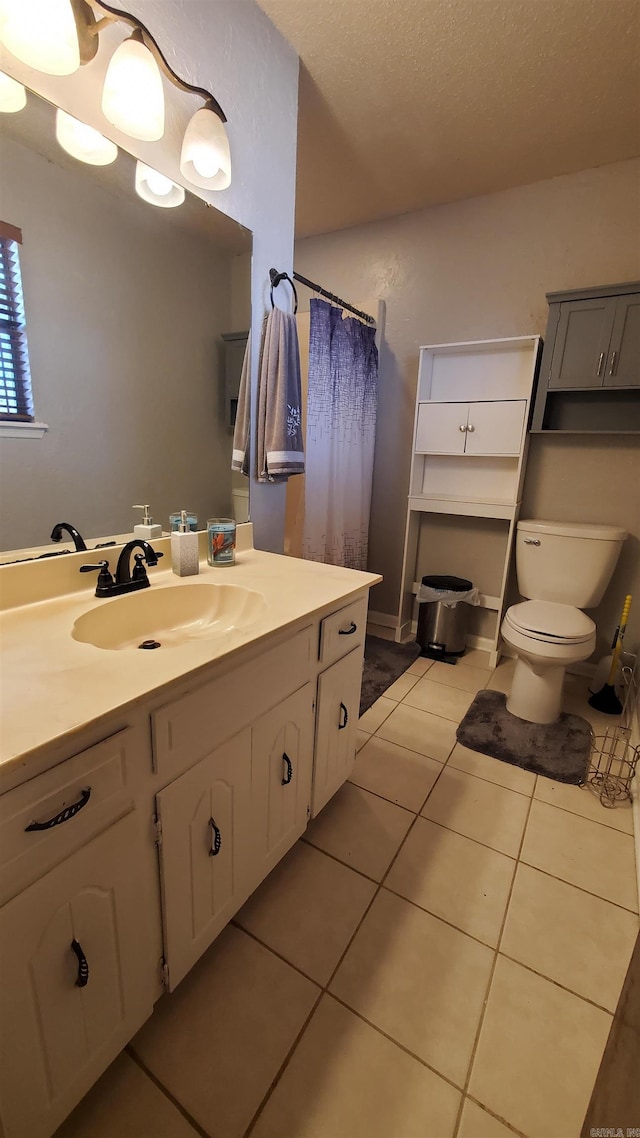 bathroom featuring a shower with curtain, tile patterned floors, a textured ceiling, toilet, and vanity