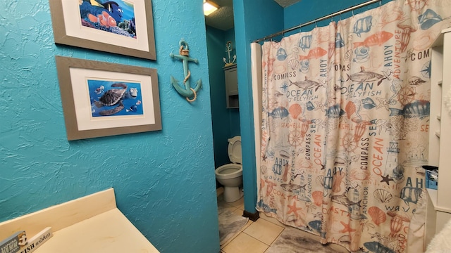 bathroom with tile patterned floors, walk in shower, and toilet