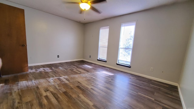 empty room featuring dark hardwood / wood-style floors and ceiling fan