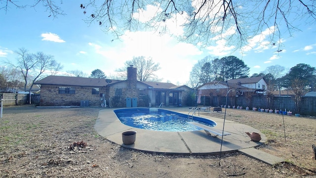 view of swimming pool with a diving board