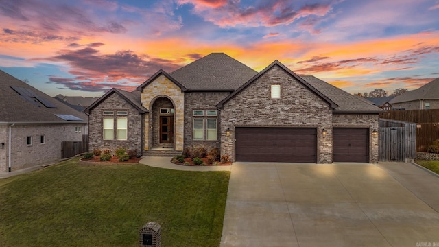 view of front of home featuring a lawn and a garage