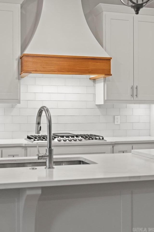 kitchen with decorative backsplash and white cabinets