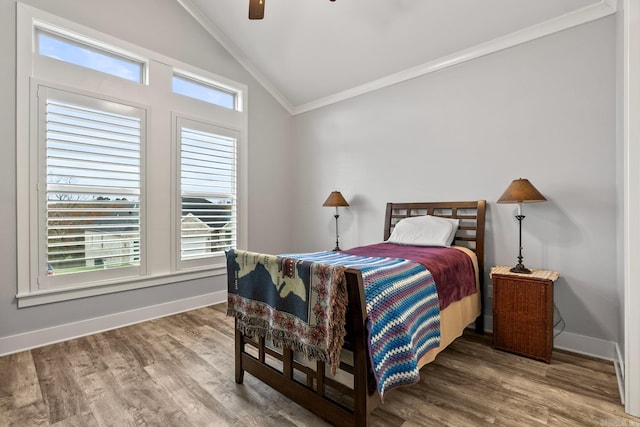 bedroom with ceiling fan, hardwood / wood-style flooring, lofted ceiling, and ornamental molding