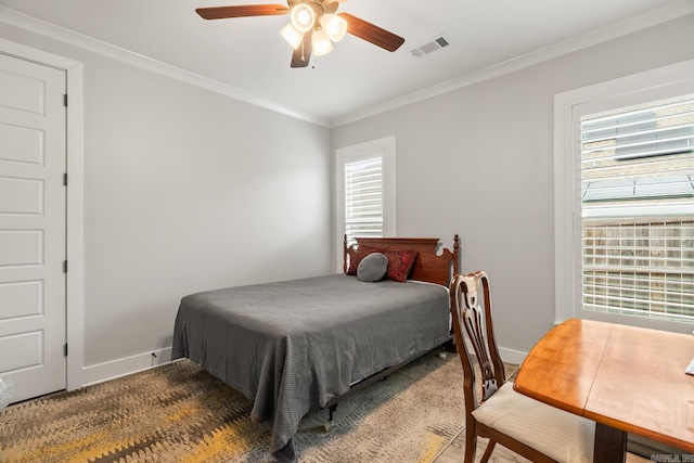 bedroom with ceiling fan, carpet floors, and crown molding