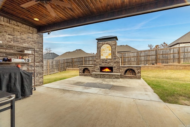 view of patio / terrace featuring a grill, ceiling fan, and an outdoor brick fireplace