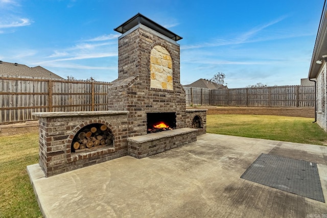 view of patio featuring an outdoor brick fireplace