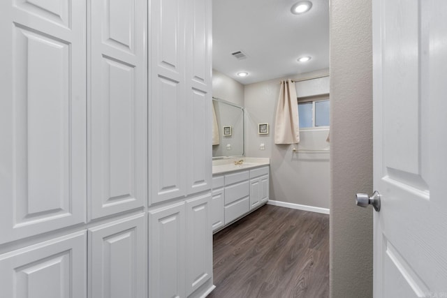 bathroom with vanity and wood-type flooring