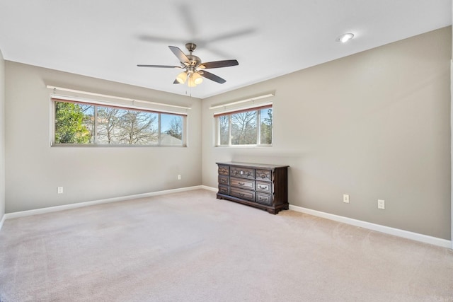 carpeted empty room featuring ceiling fan