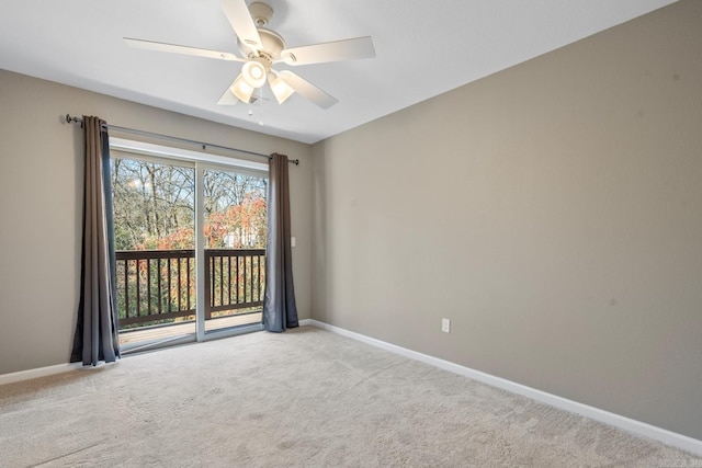 spare room featuring light colored carpet and ceiling fan