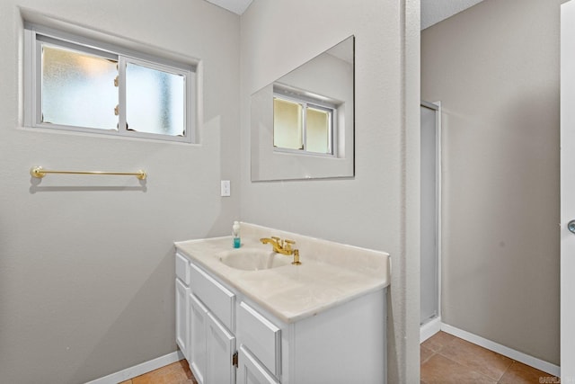 bathroom with tile patterned floors, vanity, and an enclosed shower