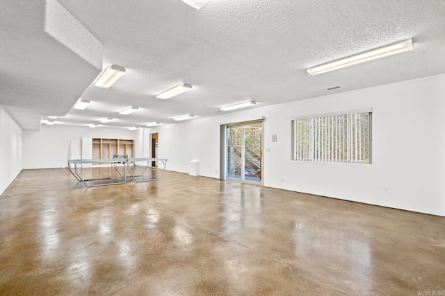 unfurnished room featuring concrete flooring and a textured ceiling