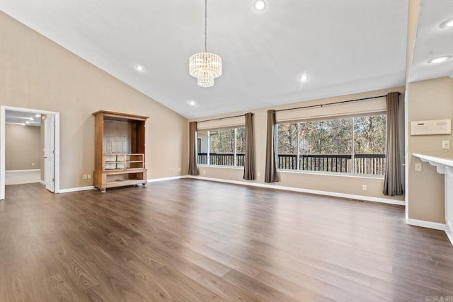 unfurnished living room with a chandelier, dark hardwood / wood-style flooring, and vaulted ceiling