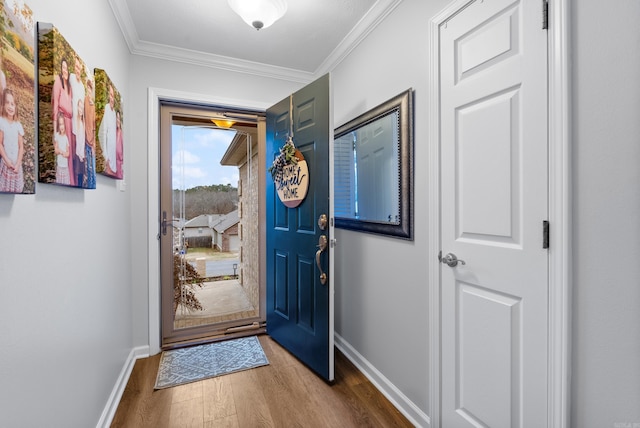 entryway with hardwood / wood-style floors and ornamental molding