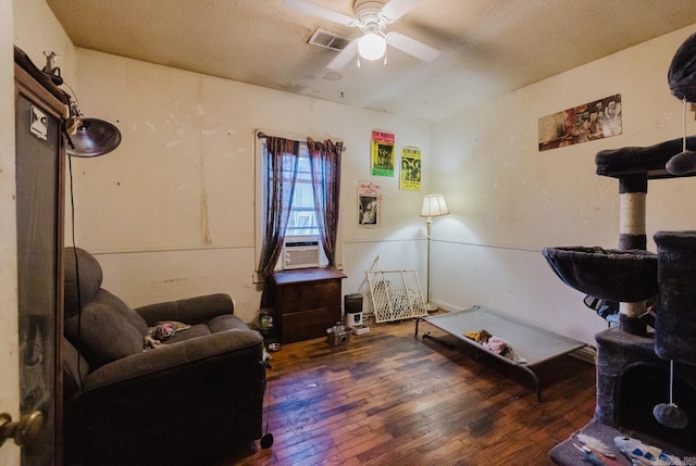 interior space with a textured ceiling, dark hardwood / wood-style floors, and ceiling fan