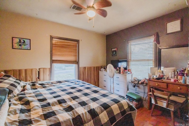 bedroom featuring multiple windows and ceiling fan