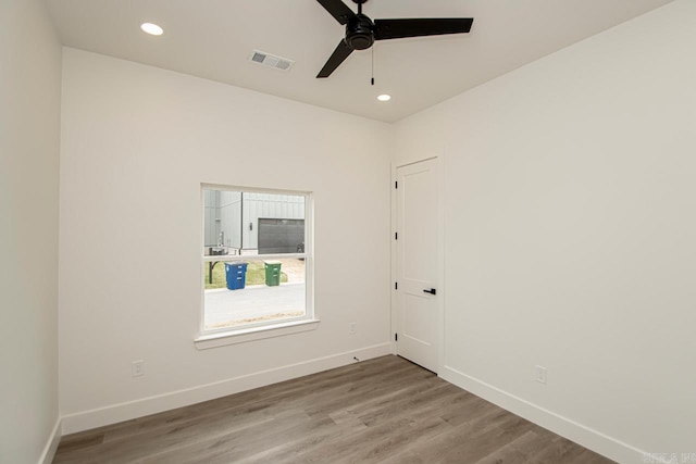 spare room with ceiling fan and hardwood / wood-style floors