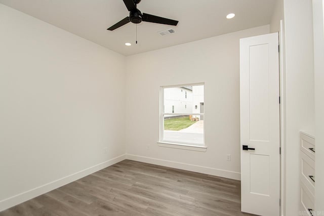 empty room featuring ceiling fan and light hardwood / wood-style flooring