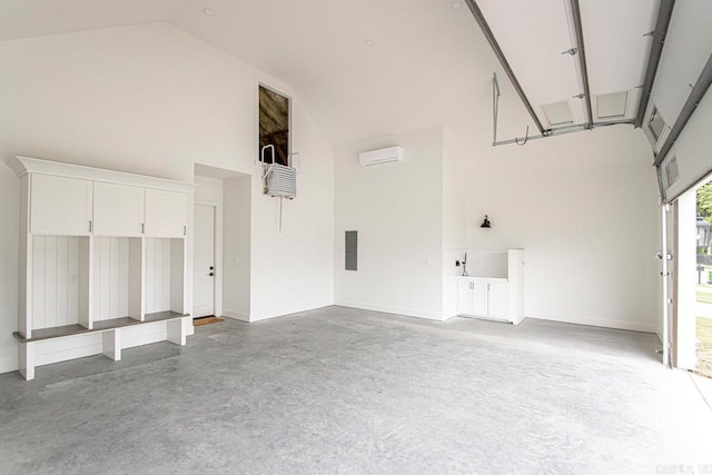 garage with a wall mounted air conditioner and electric panel