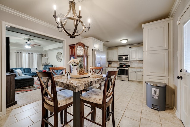 dining area with crown molding, light tile patterned floors, and ceiling fan with notable chandelier