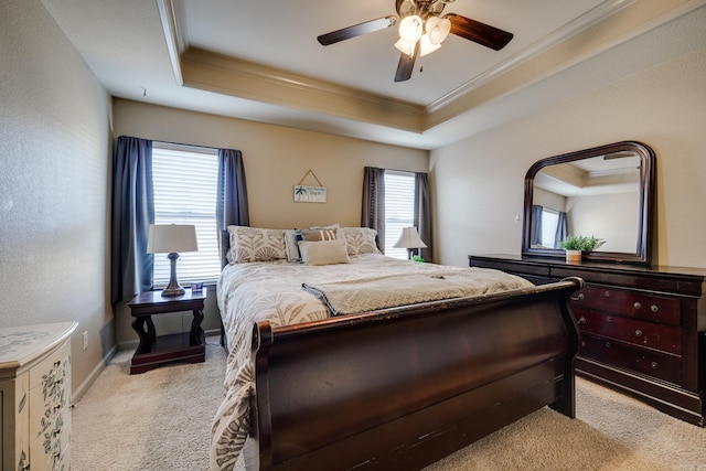 bedroom with a tray ceiling, ceiling fan, and light colored carpet