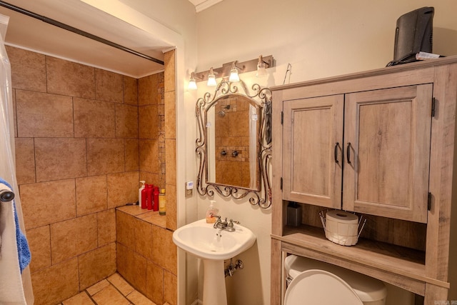 bathroom featuring tile patterned flooring and tiled shower