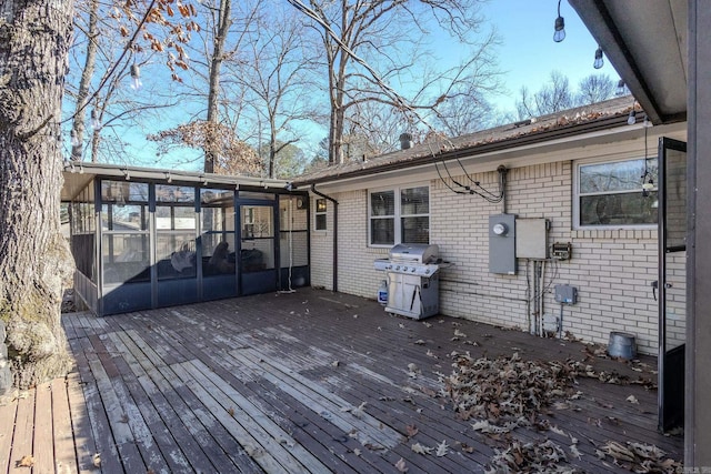 wooden terrace featuring area for grilling and a sunroom