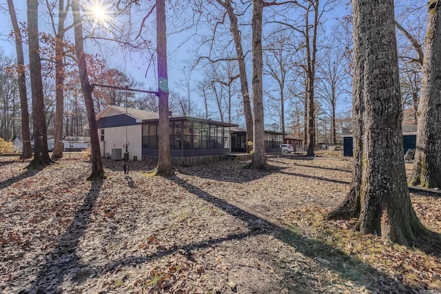 view of yard featuring cooling unit and a sunroom