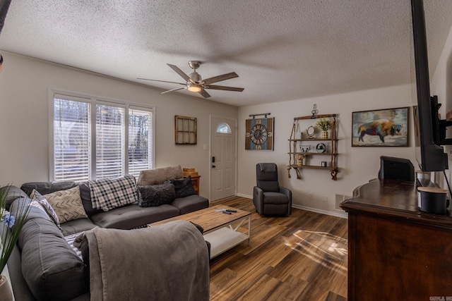 living room featuring a textured ceiling, ceiling fan, and dark hardwood / wood-style floors