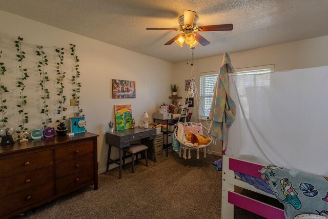 bedroom with ceiling fan, dark carpet, and a textured ceiling