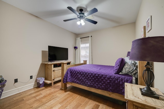 bedroom with light hardwood / wood-style flooring and ceiling fan