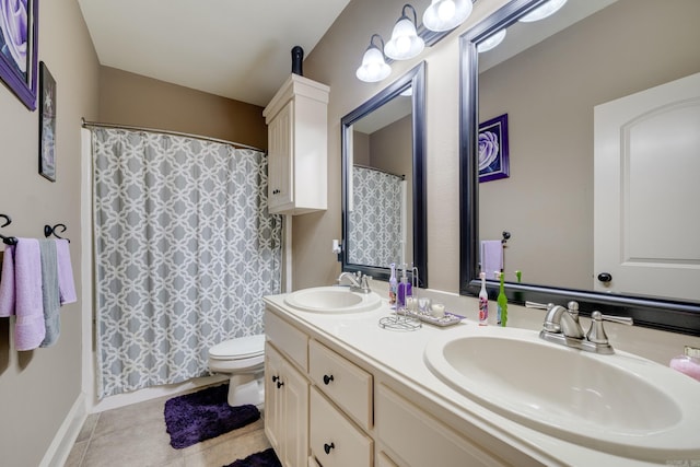 bathroom featuring tile patterned floors, vanity, and toilet