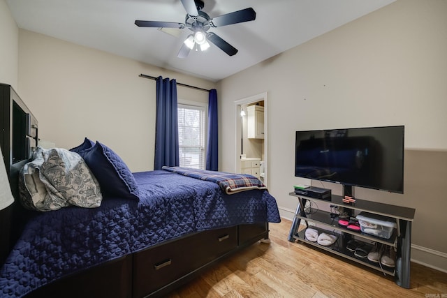 bedroom with light hardwood / wood-style floors, ensuite bath, and ceiling fan