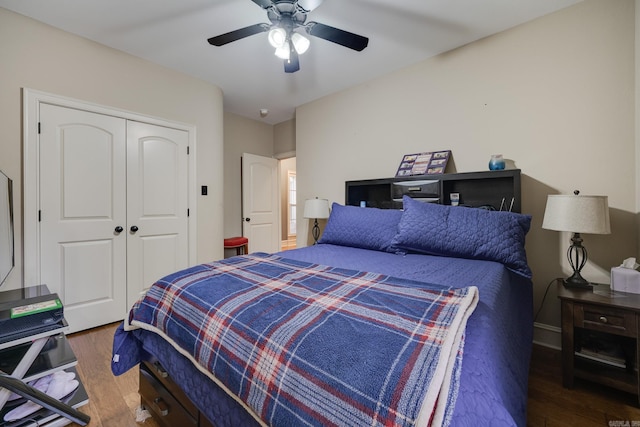 bedroom with ceiling fan, dark hardwood / wood-style flooring, and a closet