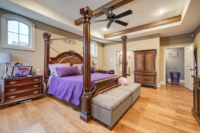 bedroom with beamed ceiling, light wood-type flooring, and ceiling fan