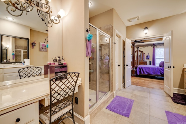 bathroom featuring tile patterned flooring, vanity, and walk in shower