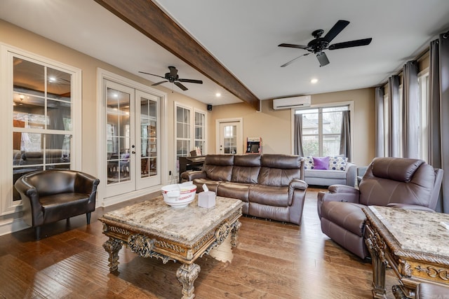 living room featuring beam ceiling, ceiling fan, french doors, a wall mounted air conditioner, and hardwood / wood-style floors